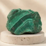 Malachite raw stone on travertine
