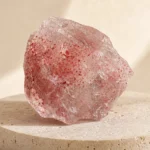 Strawberry Quartz raw stone on travertine