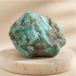 Turquoise raw stone on travertine